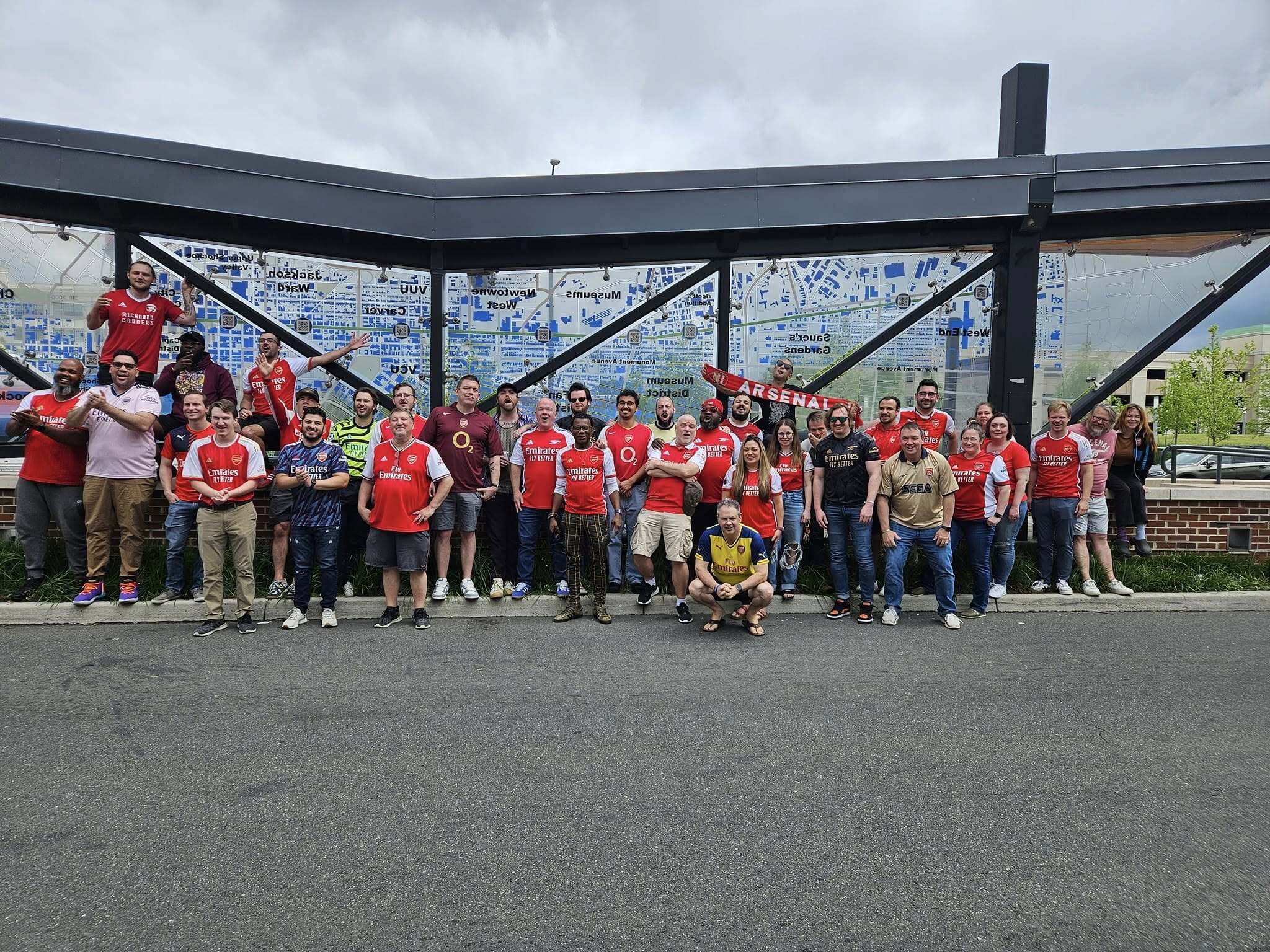 A large group of Richmond Gooners members posing together outdoors in Richmond, VA